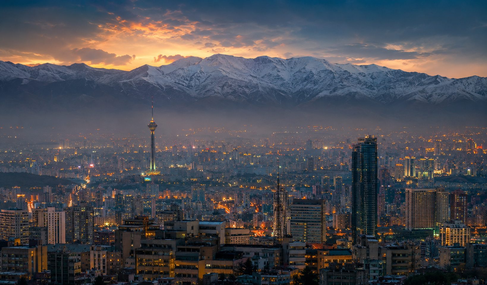 Tehran at dusk beneath the Alborz mountains